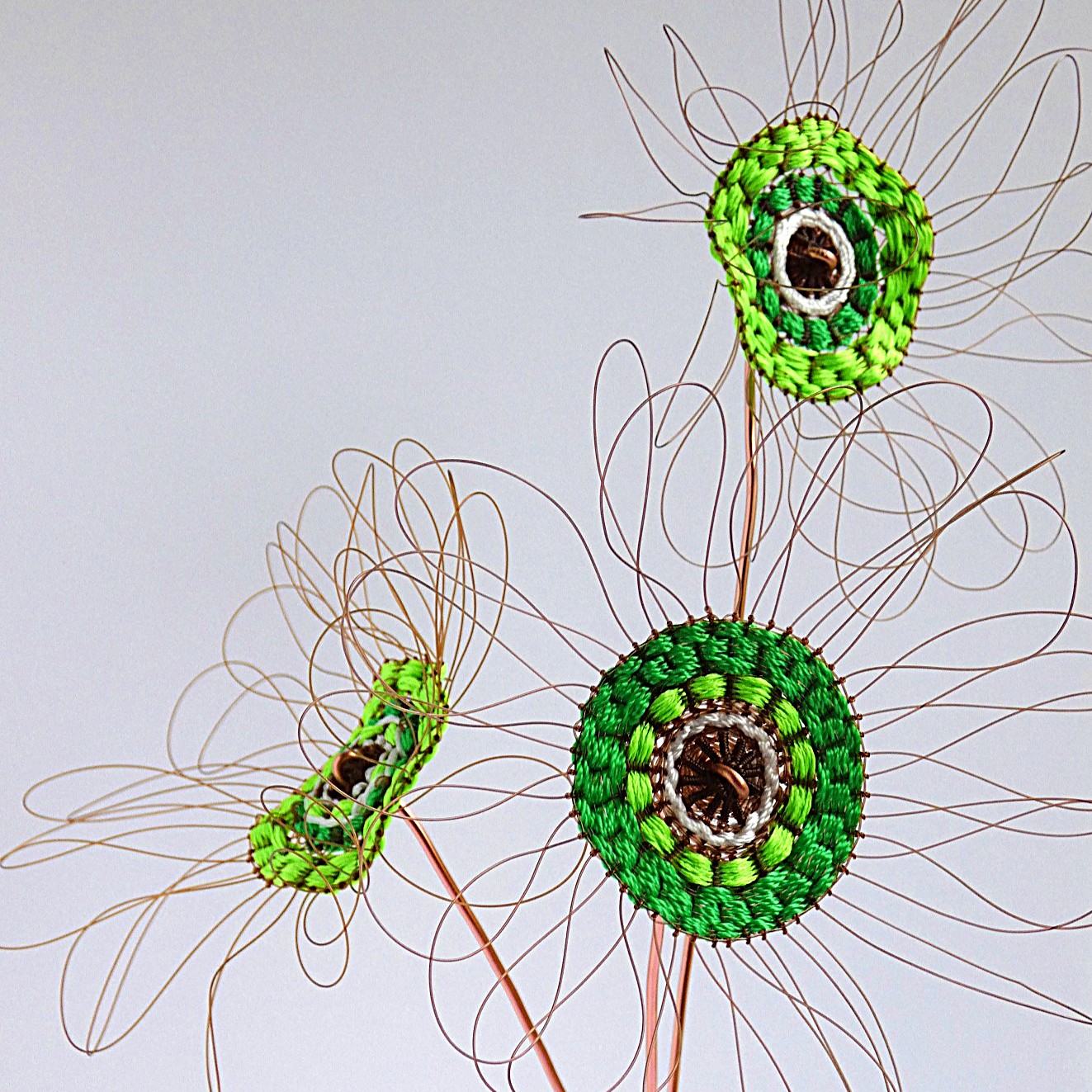 Handwoven flower made from recycled fishing line and cotton on a circular loom.